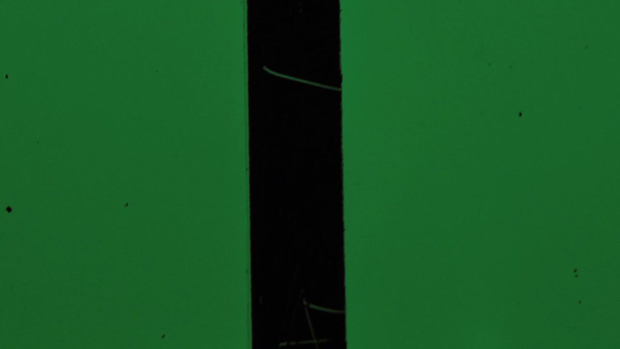 Vintage Film Strip Texture with Green Background and Dust Particles