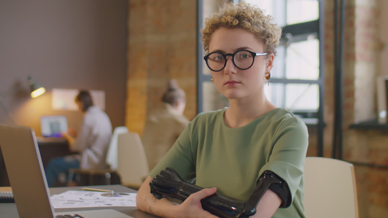 Portrait of Businesswoman with Prosthetic Arm in Office