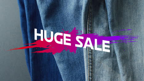 animation of huge sale text over denim trousers background
