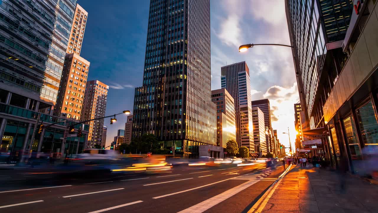 Time-lapse video of a bustling city street at sunset, with a low-angle view capturing blurred motion