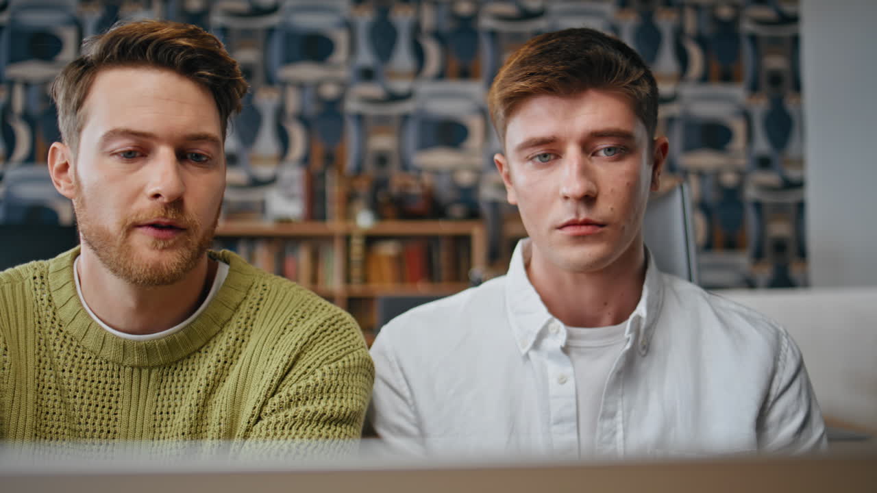 Serious coworkers looking monitor at business place closeup. Team staring pc