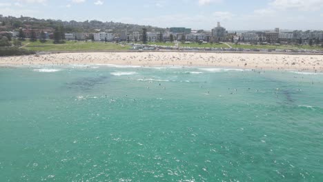 people enjoying blue sea and bondi beach at summer - sydney, nsw, australia