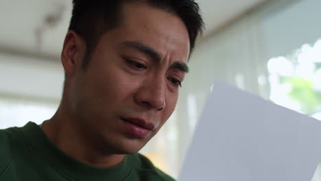 sad man reading letter