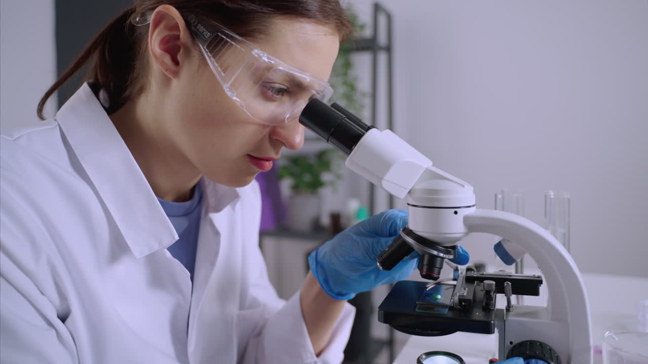Scientist using a microscope in a laboratory