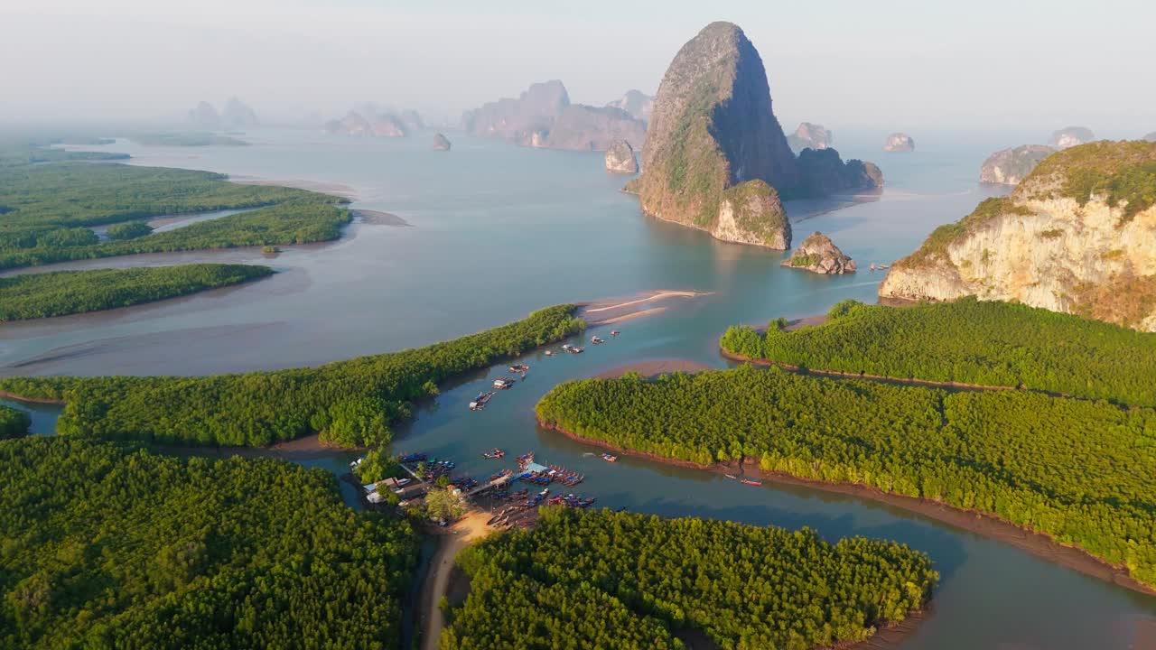 Soar over the breathtaking Phang Nga Bay, capturing stunning aerial views of its towering limestone cliffs, emerald waters, and hidden lagoons, pan shot, copy space