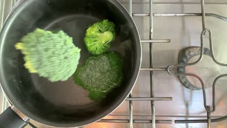 Slow-motion-broccoli-vegetable-fresh-healthy-food-in-hot-boiled-pan-pot-with-fire-stove