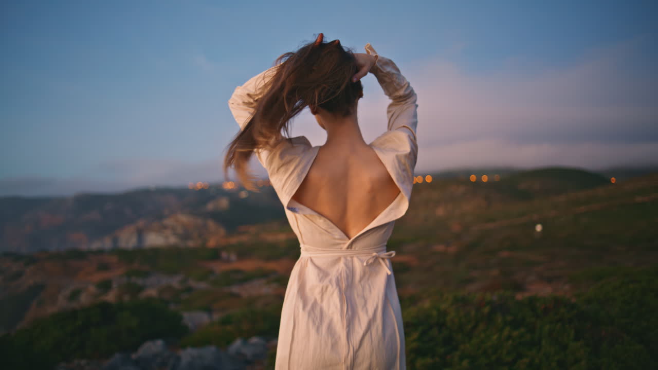 Romantic lady dancing sunset nature making relaxed movements on ocean cliff