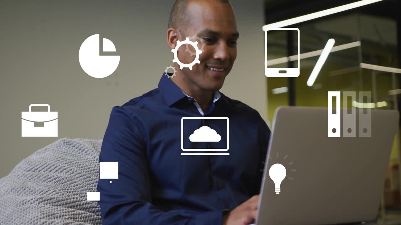 Using laptop with technology icons, smiling man creating animation at home