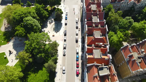 aerial view of street near the park in old town gdansk with many cars parked near the buildings in summer