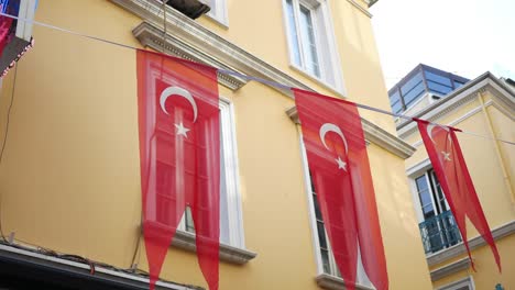 turkish flags hanging on a building in turkey