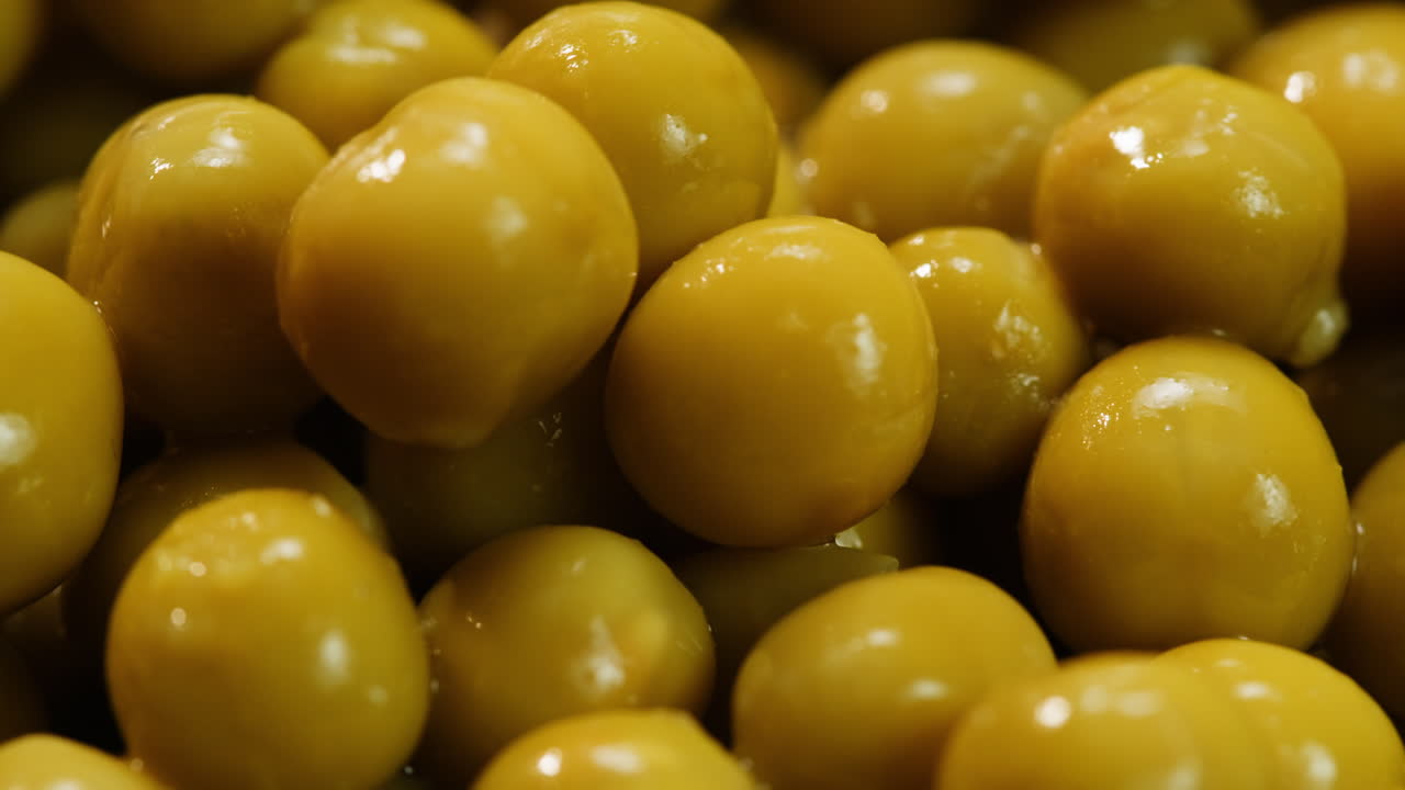 marinated pickled sweet green peas, rotation in circle. Take canned green pea kernels with a fork. High quality 4k footage