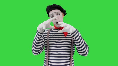 mime artist holding imaginary ball on a green screen, chroma key