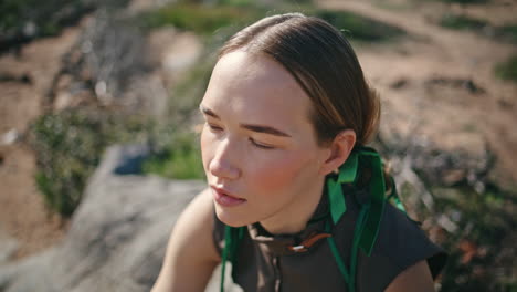 fashion model posing outdoors in sunlight closeup. young hiker resting mountains