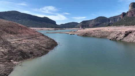 extreme low water level in lake during drought season, aerial drone view