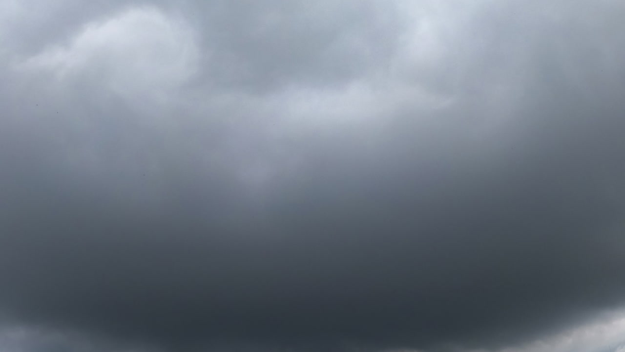 Fast-moving timelapsed clouds. Clouds drift rapidly in a timelapse, showcasing the changing weather and atmosphere above during the day