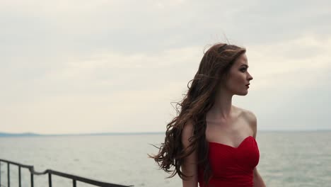 woman in red dress by the sea