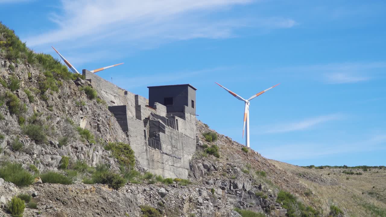Deactivated mining place ( britadeira) with some wind turbines on the background in Paul da Serra, Ponta do Sol, Madeira island, Portugal.