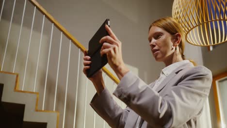 woman using a tablet in a home interior