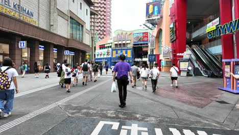 crowded pedestrian street outside universal studios store in japan
