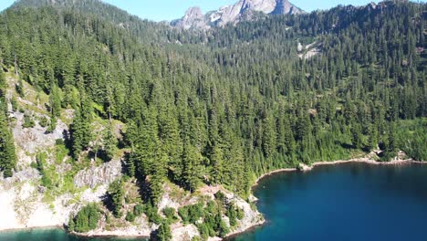 Drone-flight-over-snow-lake,-washington