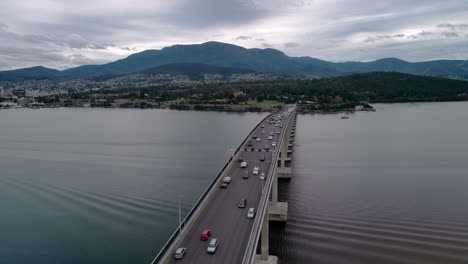 Forward-aerial-shot-of-a-bridge-in-Tasmania,-Australia-during-evening