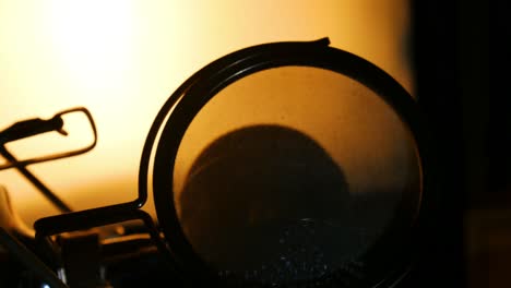 zoom out right panning shot of back lit studio microphone silhouette