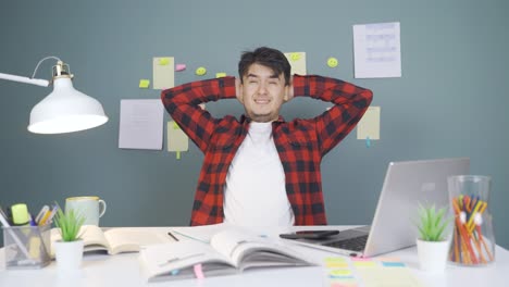 the male student who finishes the homework is happy and peaceful.