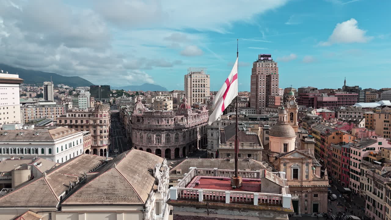 Iconic St Georges red cross flag on Grimaldina tower near Piazza Ferrari, aerial