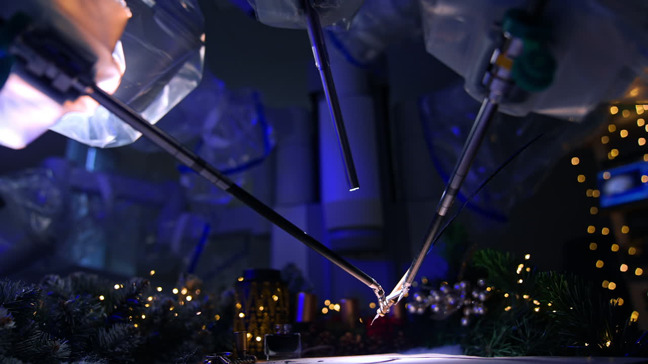 Thin tiny forceps of robotic arms managing the writing pen to write a letter. Side view. Christmas decorations and lights at backdrop.