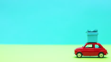 vintage car driving blue gift on the roof - stop motion