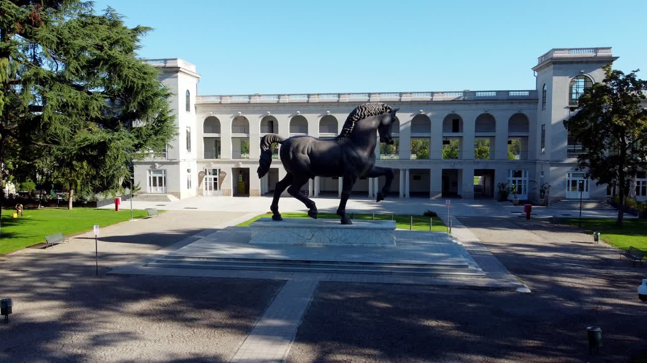 Aerial drone view of Milan’s Leonardo’s Horse monument, racecourse low angle rotate around the entrance square