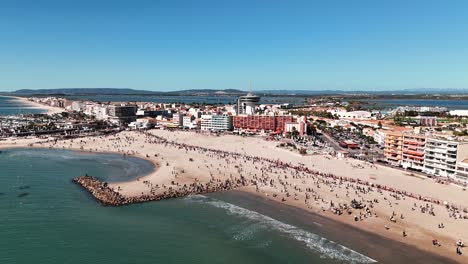 Aerial-view-capturing-vibrant-scene-of-Palavas-beach-during-fair,-France