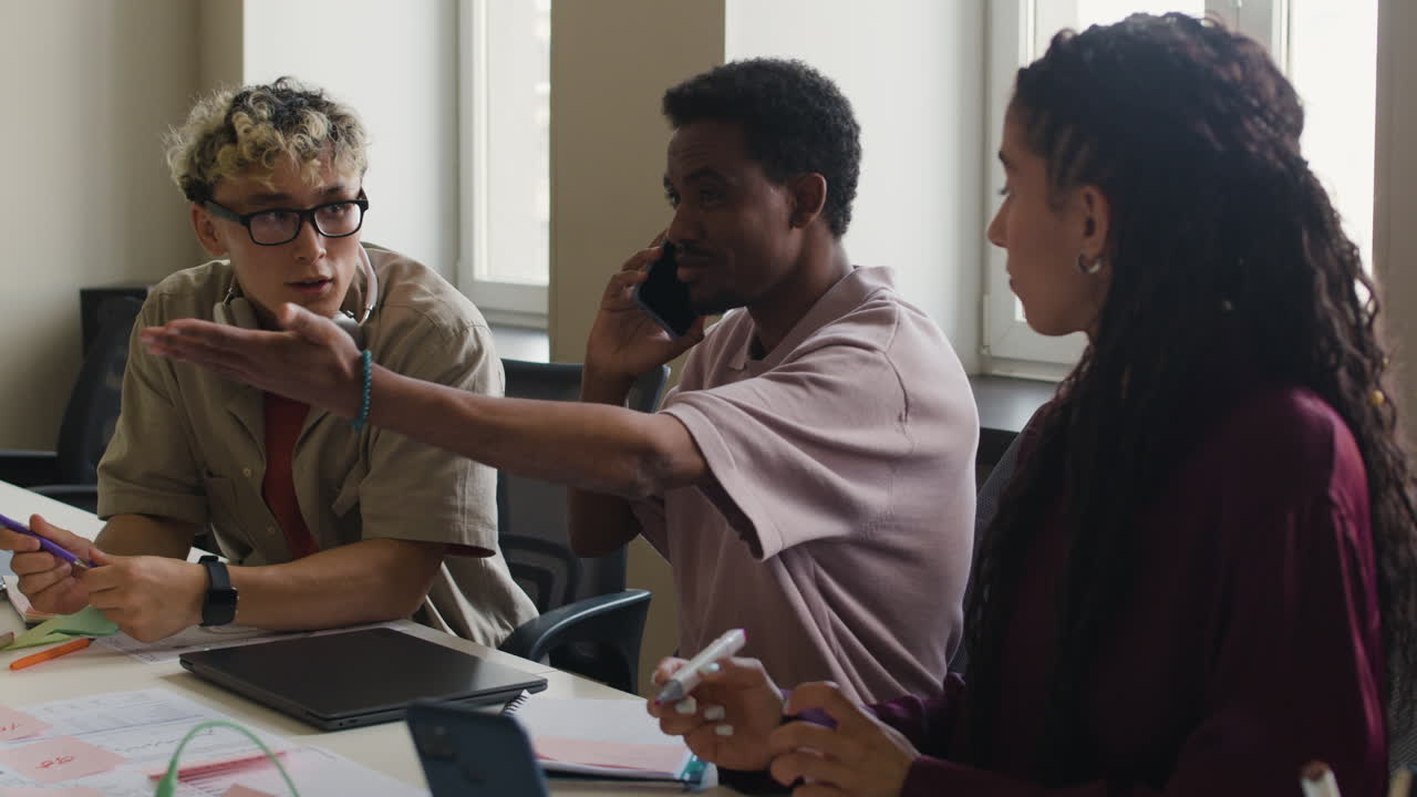 A group of diverse professionals collaboratively discussing ideas in an office meeting.