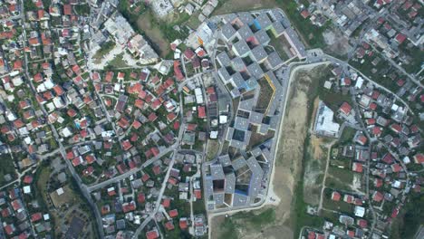 red roof houses and residential complex buildings in a charming neighborhood of tirana, captured from a top-down view