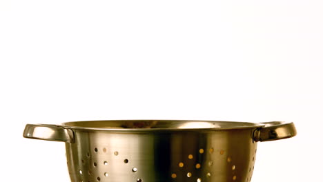 yellow pepper slices falling into colander