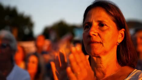 woman applauding at an outdoor event