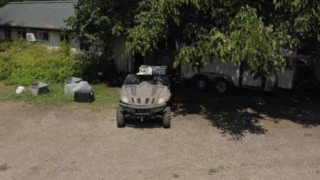 person unloading atv bike with trailer full of fresh tomato fruit boxes