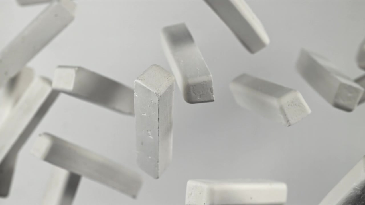 Slow Motion Close-up of White Chalk Sticks Floating