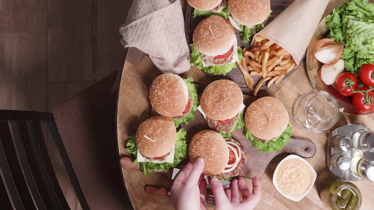 Top-down view of burgers and french fries on a table