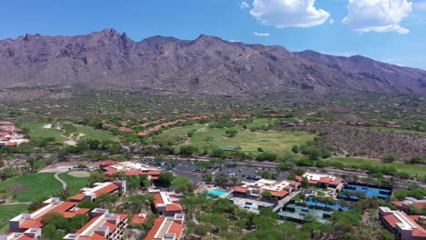 Golf-course-near-Catalina-Mountains,-Tucson.-Aerial-backward