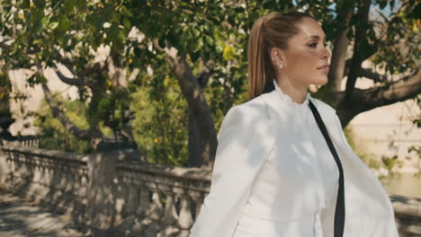 Stylish-young-woman-walking-through-the-old-park.