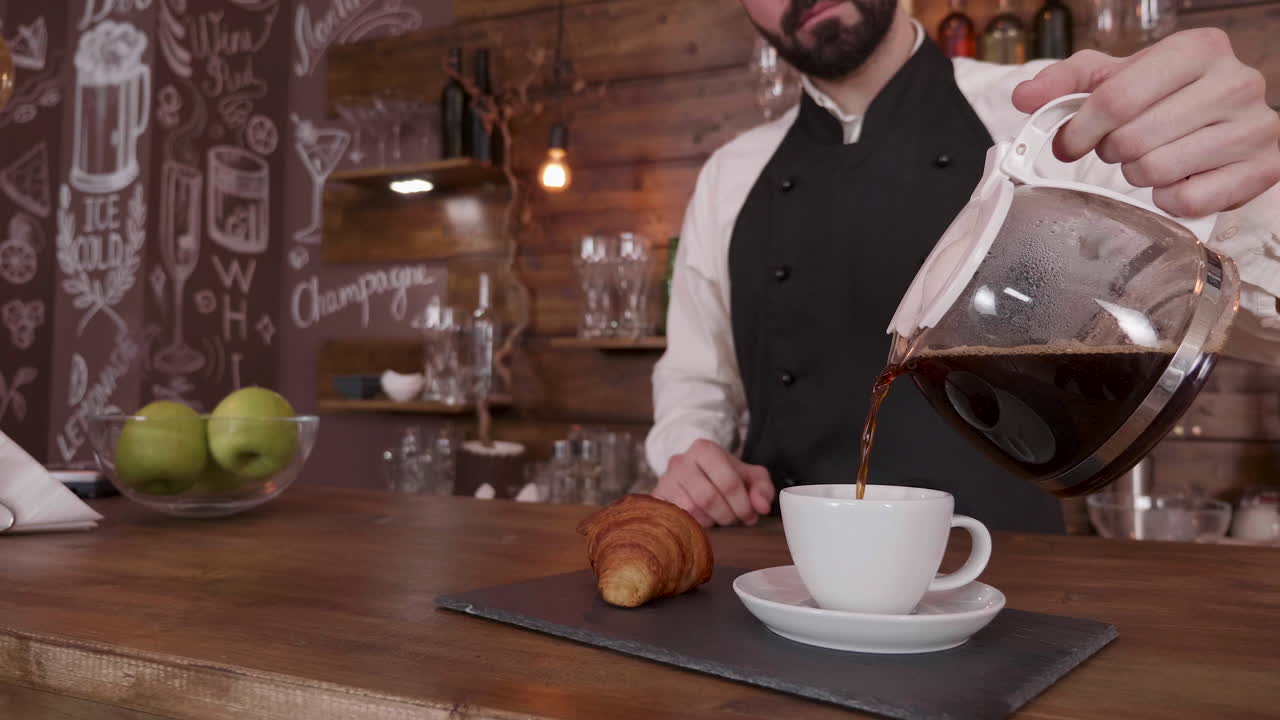 Barista pouring coffee in a cafe