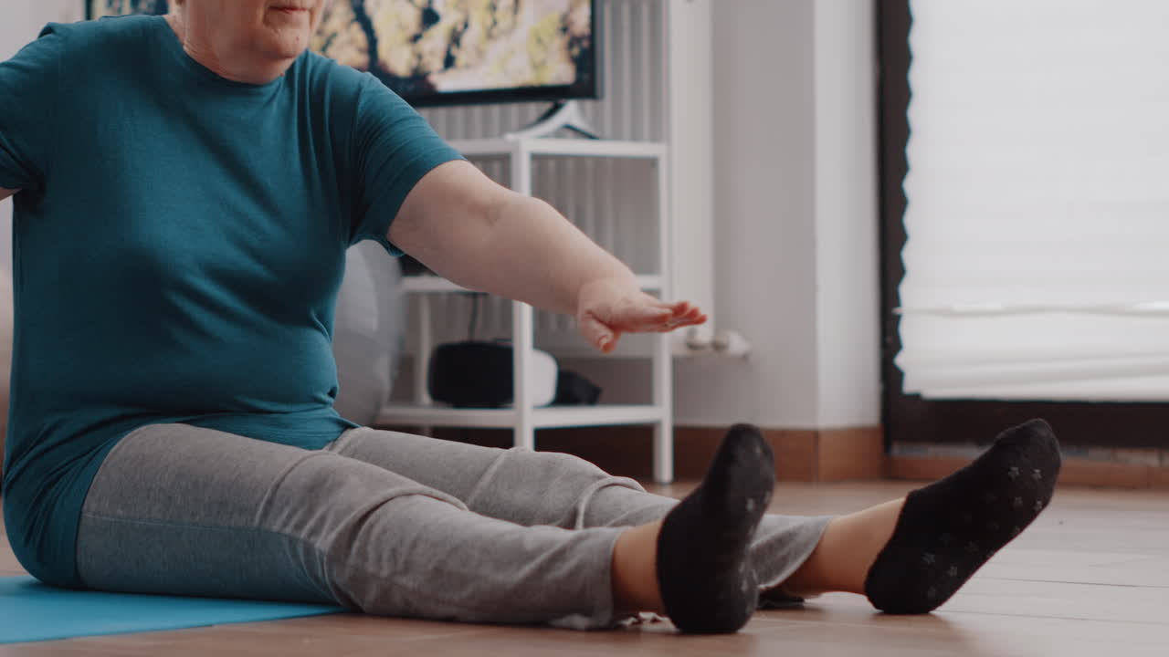 Close up of pensioner doing physical exercise to stretch muscles