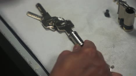 a man making a lock fit a key