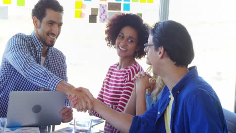 happy colleagues shaking hands 4k