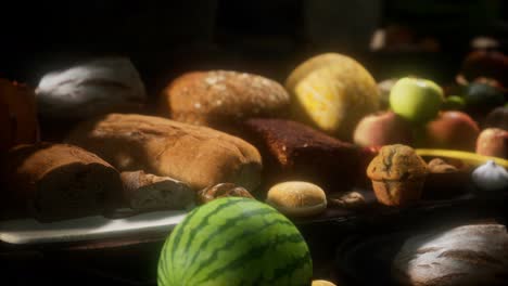 food table with wine barrels and some fruits, vegetables and bread