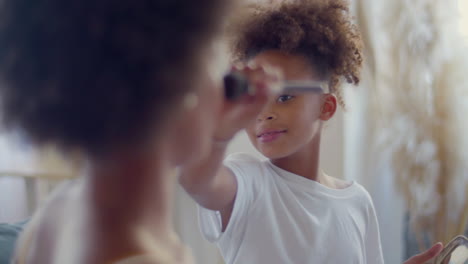 cute black girl doing make-up on her mother