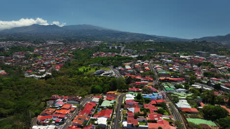drone flying over a streets and a community of homes, in san jose, costa rica
