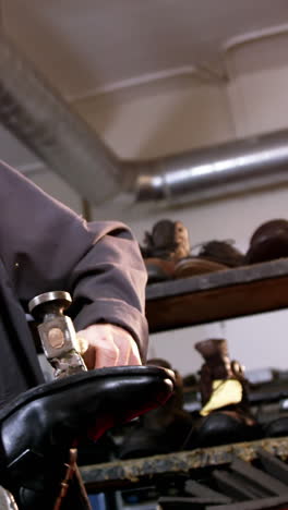shoemaker hammering on a shoe