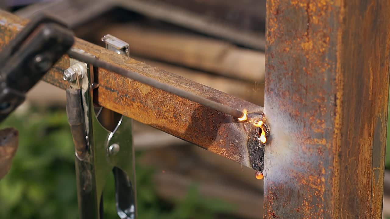 close view worker uses welding for fence details connecting